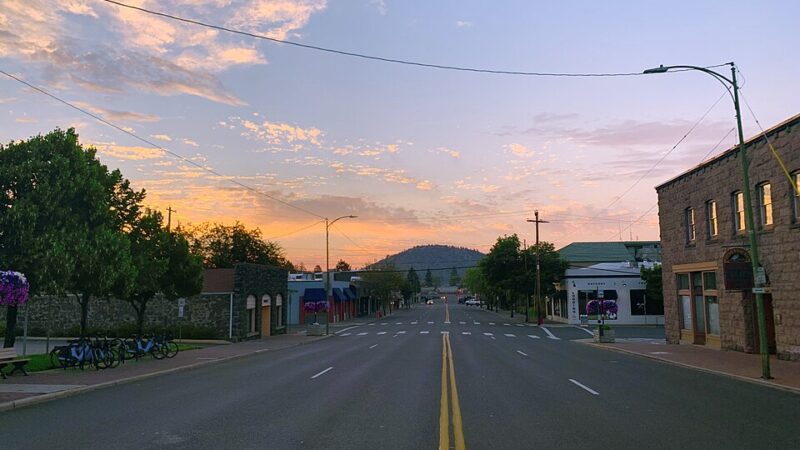 Downtown Bend Oregon street with Pilot Butte in the distance