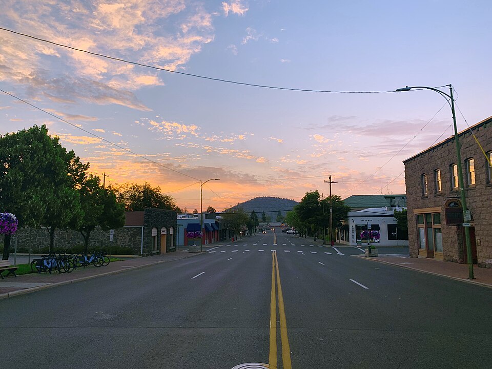 Downtown Bend Oregon street with Pilot Butte in the distance