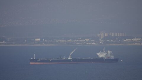 Oil tanker ship anchored offshore near a port