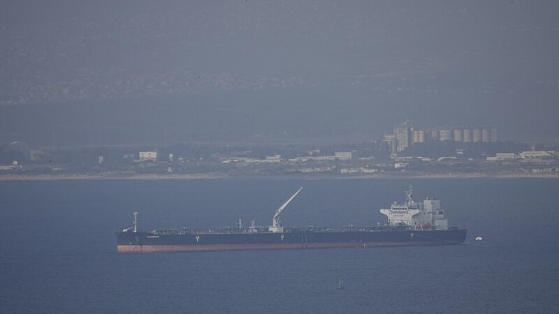 Oil tanker ship anchored offshore near a port